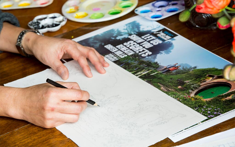 Artist Gabby Malpas creating the sketches. Photo: Tourism New Zealand