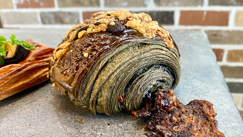 Vegemite croissant featuring activated charcoal, gruyere, cheddar and whipped Vegemite. Masa Byron Bay