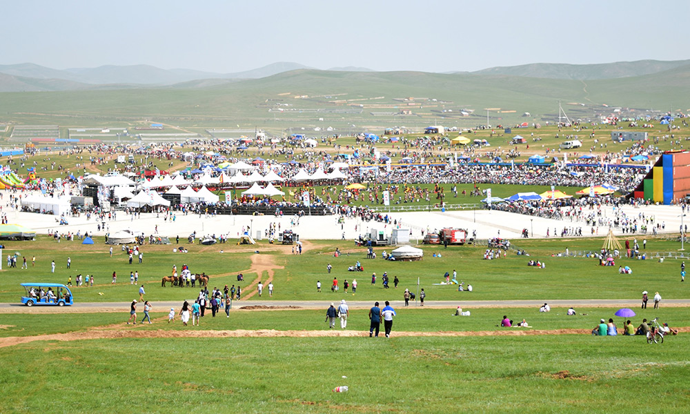 Games include Mongolian wrestling, horse racing, and archery. Photo: Belgutei/Unsplash.
