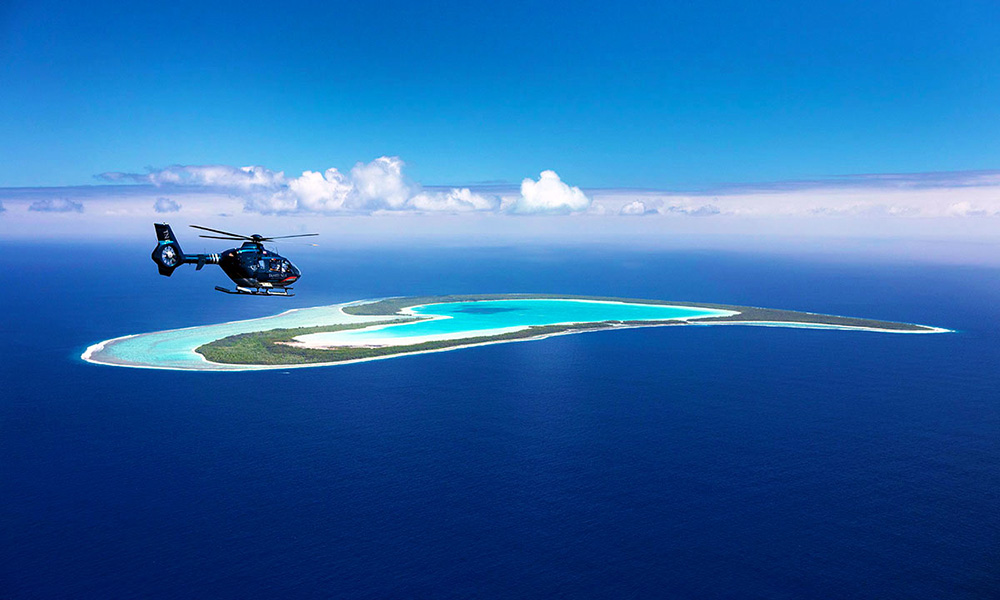 Take a scenic helicopter flight to the heart shaped island of Tupai. Credit: Tahiti Nui Helicopters