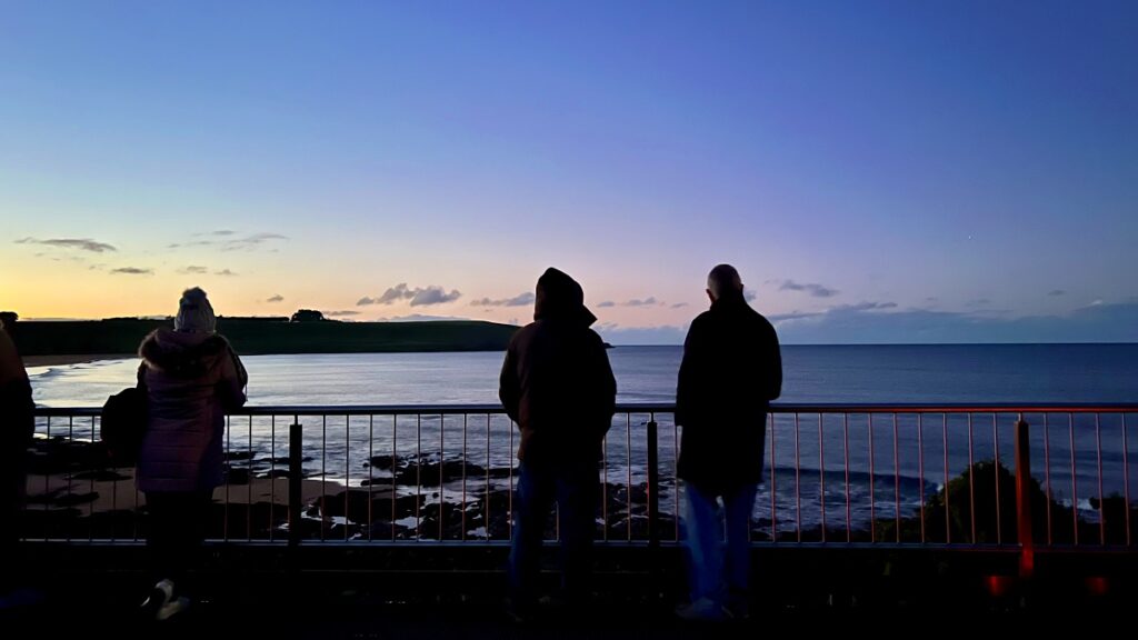 Waiting for penguins to arrive at Godfreys Beach, Stanley.