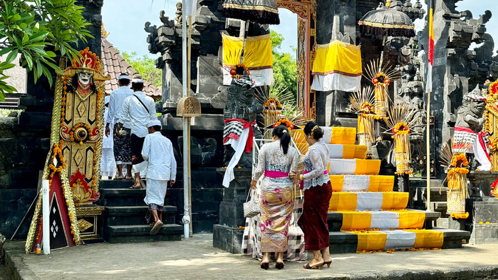 Locals purify themselves with splashes of water before entering the temple. 
